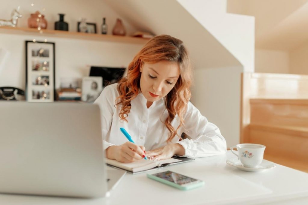 woman writing in a notebook